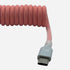 USB-C to USB-A premium light pink coiled keyboard cable close-up