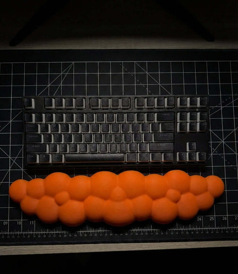 Cloud shaped orange wrist rest for keyboard desk setup