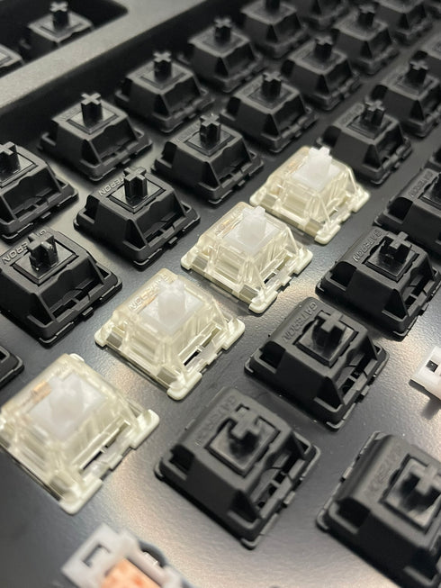 Angled keyboard shot featuring installed Gateron KS-9 White switches with black Gateron switches surrounding them.