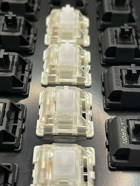 Top-down view of multiple Gateron KS-9 White switches installed in a keyboard plate among other switch types.