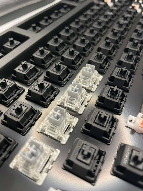 Top-down view of a keyboard with a row of Gateron SMD Silver Pro switches installed in the center.