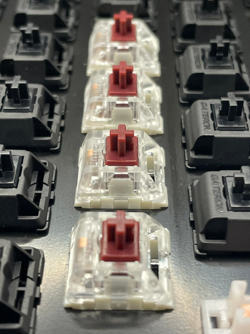 Kailh Speed Coppery switches geïnstalleerd in een toetsenbord naast zwarte Gateron switches.
