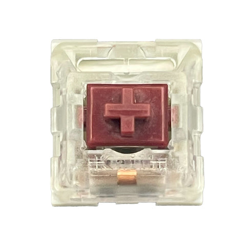 Bovenaanzicht van de Kailh Speed Coppery switch met rode stem en transparante behuizing.