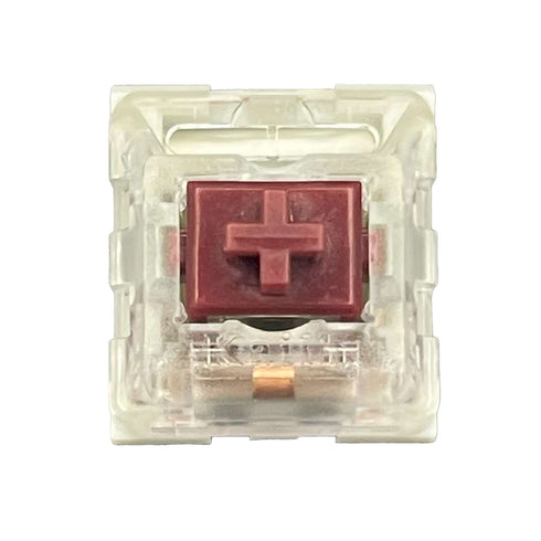 Bovenaanzicht van de Kailh Speed Coppery switch met rode stem en transparante behuizing.