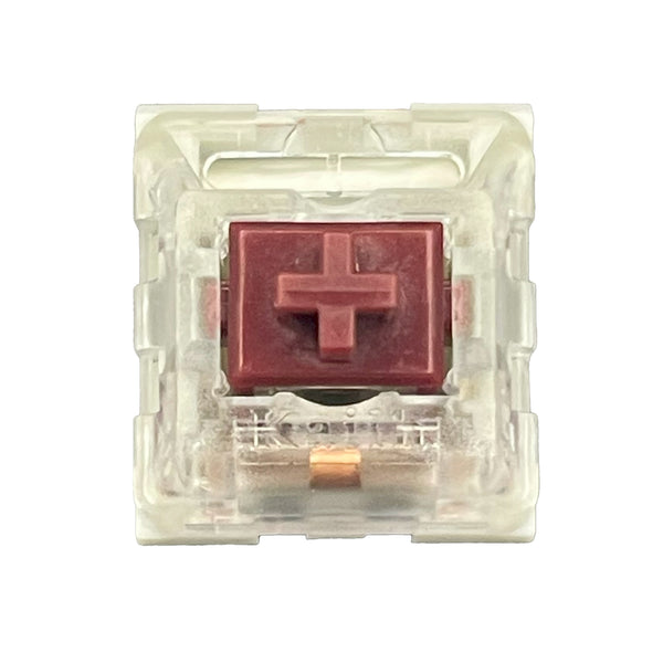 Bovenaanzicht van de Kailh Speed Coppery switch met rode stem en transparante behuizing.