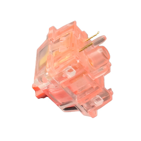 KTT Strawberry switch in schuine hoek met zicht op pinnen en transparante behuizing – lineaire mechanische switch