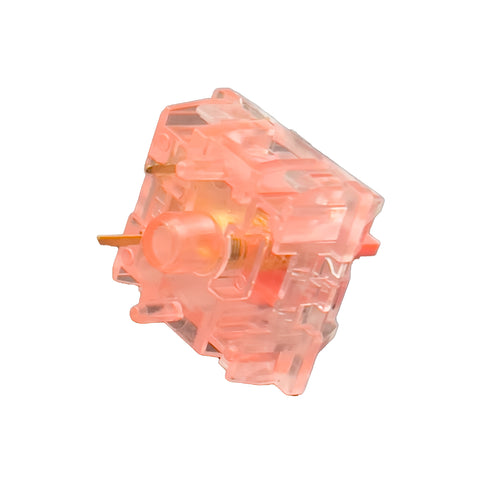 Onderkant van een KTT Strawberry switch met zicht op pinnen en schacht – roze stem met transparante behuizing